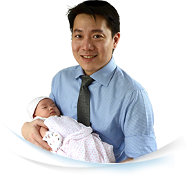 Dr Jonathan Wee Yeow Sherng holding a baby