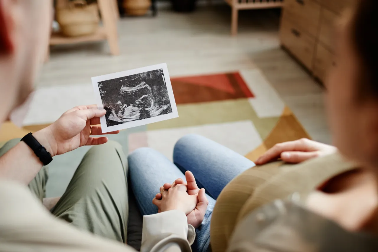 Couple reviewing an ultrasound image during a fertility consultation 